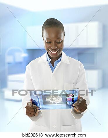 African American doctor using digital tablet in doctor's office View Large Photo Image Stock Image - African American doctor using digital tablet in doctor's office. Fotosearch