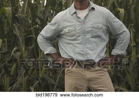 Stock Photo - African American farmer standing with hands on hips. Fotosearch