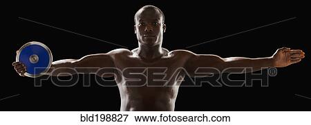 Stock Photo - African American man holding track and field discus. Fotosearch