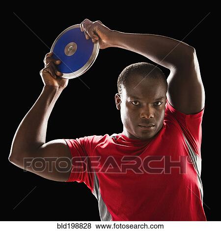 Stock Photo - African American man holding track and field discus. Fotosearch
