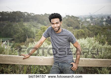 African American man leaning on fence in remote area View Large Photo Image Stock Photo - African American man leaning on fence in remote area. Fotosearch