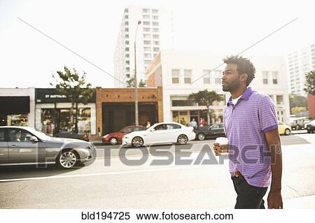 African American man with coffee cup walking on sidewalk View Large Photo Image Stock Photography - African American man with coffee cup walking on sidewalk. Fotosearch