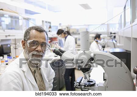 African American scientist using microscope in laboratory View Large Photo Image Stock Image - African American scientist using microscope in laboratory. Fotosearch