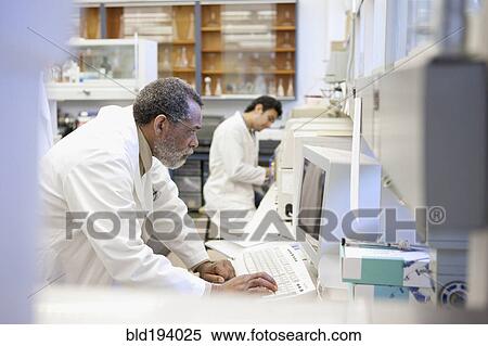 Stock Photography - African American scientist working in laboratory. Fotosearch