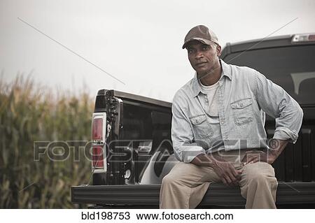 African American sitting on back of pick-up truck View Large Photo Image Stock Image - African American sitting on back of pick-up truck. Fotosearch