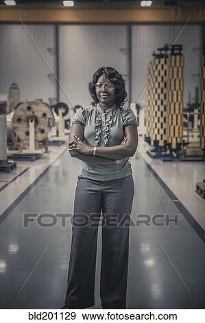 Stock Photo - African American worker standing in factory. Fotosearch