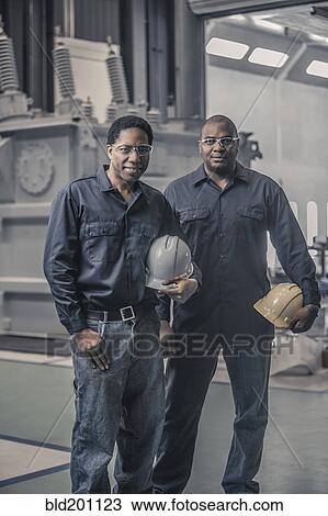 African American workers standing together in factory View Large Photo Image Stock Image - African American workers standing together in factory. Fotosearch