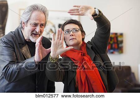 Stock Photo - Art gallery curator talking with client. Fotosearch