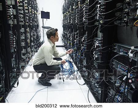 Asian businessman working in server room View Large Photo Image Stock Image - Asian businessman working in server room. Fotosearch