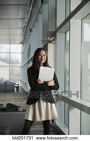 Asian businesswoman holding clipboard View Large Photo Image Stock Image - Asian businesswoman holding clipboard. Fotosearch