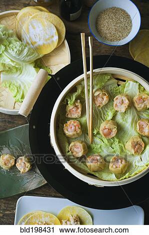 Asian dumpling in steamer with cabbage View Large Photo Image Stock Image - Asian dumpling in steamer with cabbage. Fotosearch