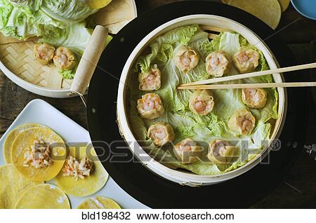 Asian dumpling in steamer with cabbage View Large Photo Image Stock Image - Asian dumpling in steamer with cabbage. Fotosearch