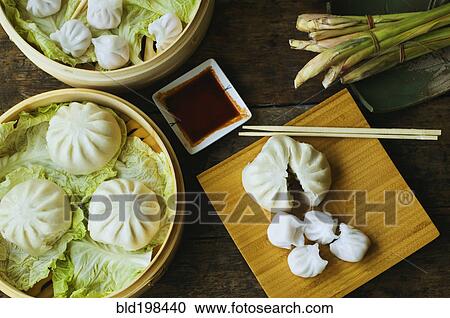 Asian dumpling in steamer with cabbage View Large Photo Image Stock Image - Asian dumpling in steamer with cabbage. Fotosearch