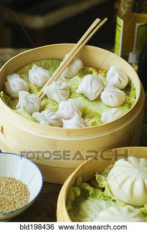 Asian dumpling in steamer with cabbage View Large Photo Image Stock Photograph - Asian dumpling in steamer with cabbage. Fotosearch