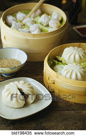 Stock Photography - Asian dumpling in steamer with cabbage. Fotosearch