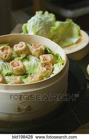 Asian dumplings in steamer with cabbage View Large Photo Image Stock Photo - Asian dumplings in steamer with cabbage. Fotosearch