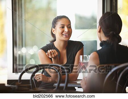 Asian friends sitting together in cafe View Large Photo Image Stock Photograph - Asian friends sitting together in cafe. Fotosearch