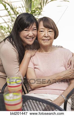 Asian mother and daughter hugging View Large Photo Image Stock Photo - Asian mother and daughter hugging. Fotosearch