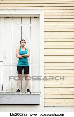 Asian woman in sportswear standing on loading dock View Large Photo Image Stock Image - Asian woman in sportswear standing on loading dock. Fotosearch