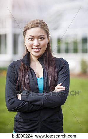 Picture - Asian woman with arms crossed. Fotosearch