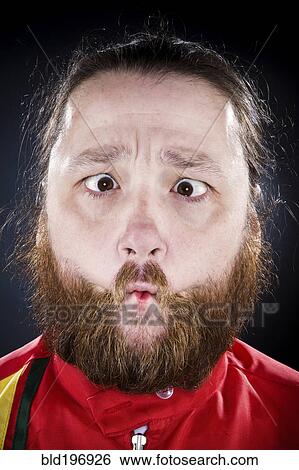 Stock Photograph - Bearded man puckering his mouth. Fotosearch