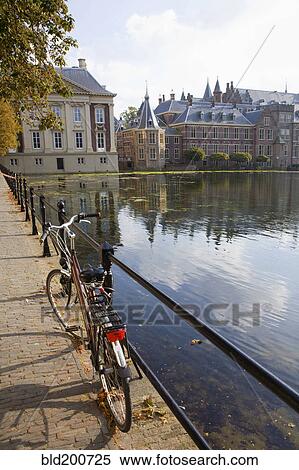 Stock Photography - Bicycle and ornate Dutch buildings near pond. Fotosearch
