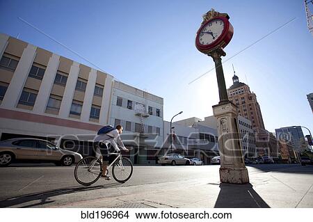 Bicycle messenger riding on city street View Large Photo Image Picture - Bicycle messenger riding on city street. Fotosearch