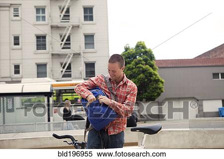 Stock Photography - Bicycle messenger stopping on city street. Fotosearch