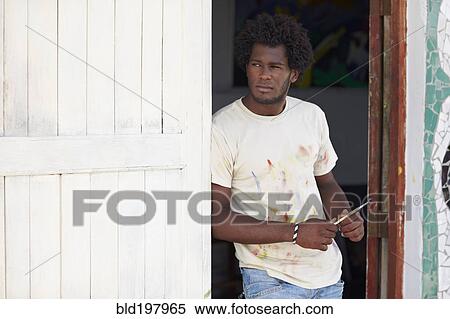 Stock Photography - Black artist leaning in doorway. Fotosearch