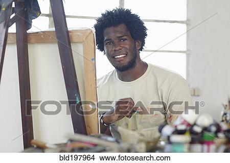 Picture - Black artist painting in art studio. Fotosearch