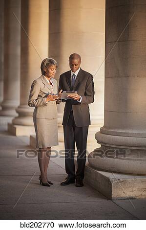 Stock Image - Black business people talking. Fotosearch