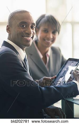 Black business people using tablet computer View Large Photo Image Stock Image - Black business people using tablet computer. Fotosearch