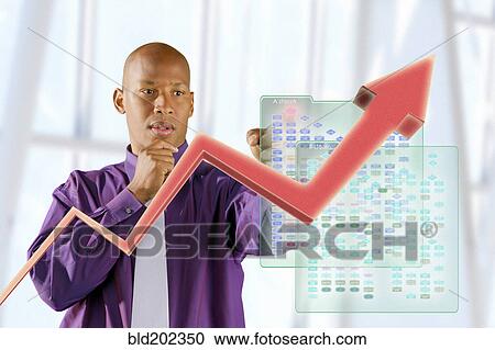 Black businessman looking at line graph View Large Photo Image Stock Image - Black businessman looking at line graph. Fotosearch