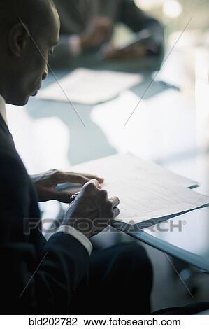 Black businessman reading notes View Large Photo Image Stock Image - Black businessman reading notes. Fotosearch