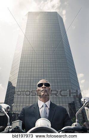 Black businessman riding motorcycle in city View Large Photo Image Stock Image - Black businessman riding motorcycle in city. Fotosearch