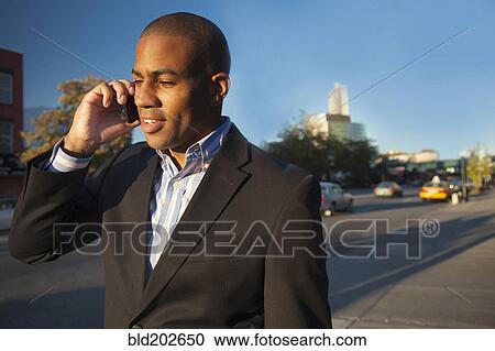 Black businessman talking on cell phone View Large Photo Image Stock Image - Black businessman talking on cell phone. Fotosearch