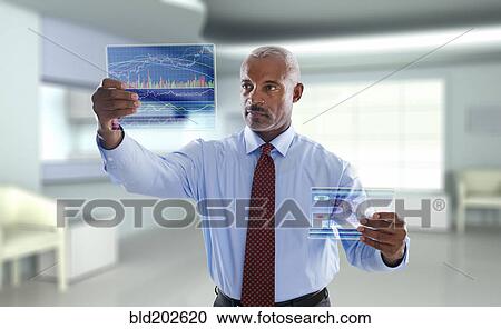 Stock Image - Black businessman using digital display. Fotosearch
