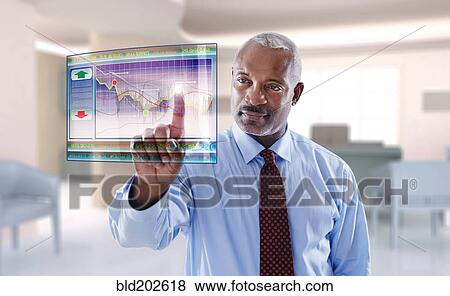 Stock Photo - Black businessman using digital display. Fotosearch