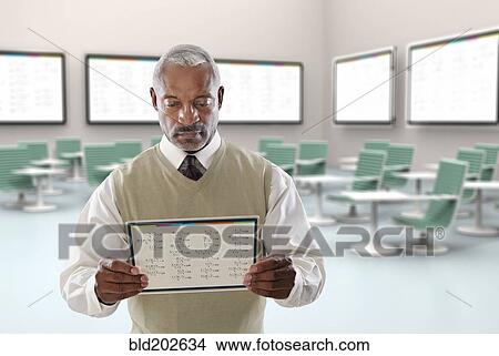 Picture - Black businessman using digital tablet in conference room. Fotosearch