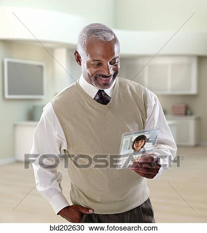 Stock Image - Black businessman using digital tablet in office. Fotosearch