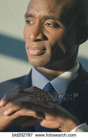 Black businessman with hands folded View Large Photo Image Stock Photo - Black businessman with hands folded. Fotosearch