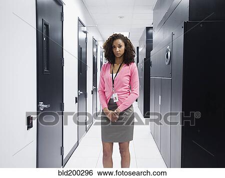 Black businesswoman standing in server room View Large Photo Image Stock Photograph - Black businesswoman standing in server room. Fotosearch