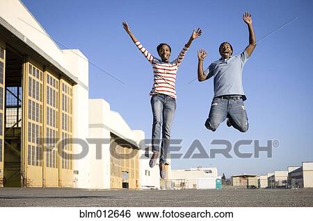 Black couple cheering and jumping View Large Photo Image Stock Photograph - Black couple cheering and jumping. Fotosearch