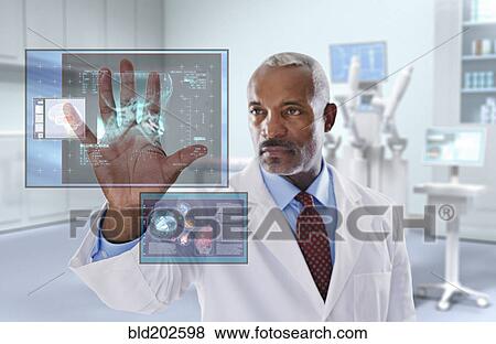 Stock Photo - Black doctor looking at digital display in doctor's office. Fotosearch