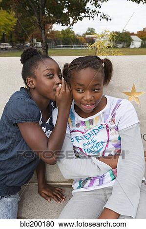 Black girls whispering together View Large Photo Image Stock Image - Black girls whispering together. Fotosearch