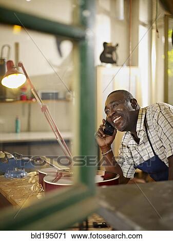 Black lute maker talking on telephone View Large Photo Image Stock Image - Black lute maker talking on telephone. Fotosearch