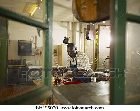 Black lute maker working in workshop View Large Photo Image Stock Image - Black lute maker working in workshop. Fotosearch