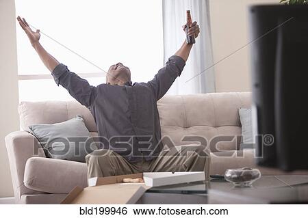 Black man cheering and watching television View Large Photo Image Stock Photograph - Black man cheering and watching television. Fotosearch