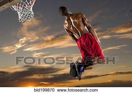 Stock Image - Black man playing basketball. Fotosearch