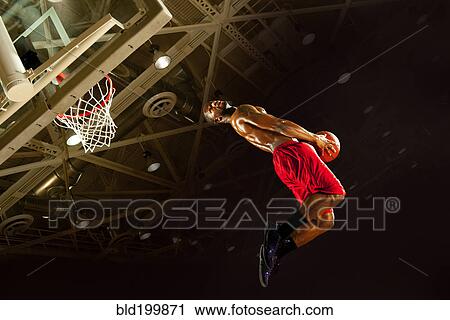 Stock Image - Black man playing basketball. Fotosearch